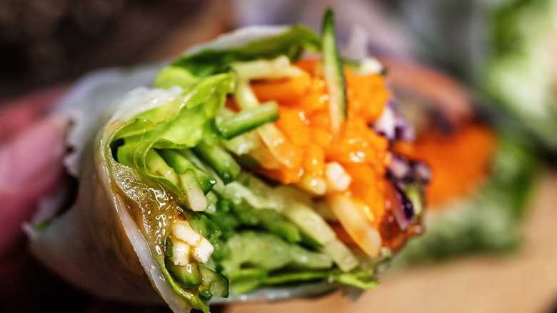 A wrap filled with various veggies including red cabbage