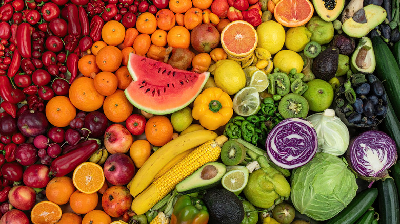 Green and red cabbage and various brightly colored fresh produce