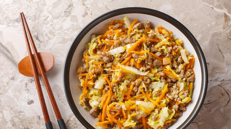 Egg roll in a bowl with chopsticks