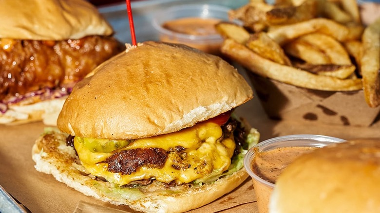 Cheeseburger with fries in the background blurred at HiHo Cheeseburger