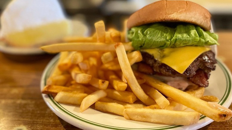 Cheeseburger with side of fries on a plate from Pie 'N Burger