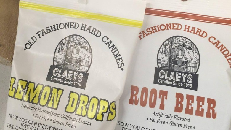 Two bags of Claeys Old Fashioned Hard Candies, Lemon Drops and Root Beer flavors