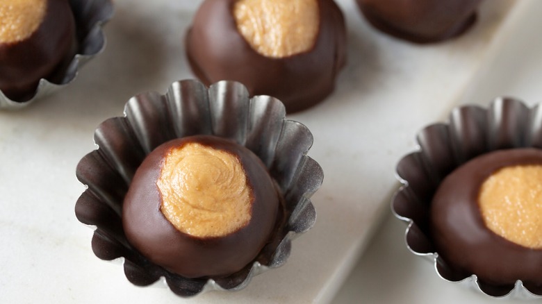 Smooth and creamy buckeye chocolate and peanut butter candies chocolates on white background