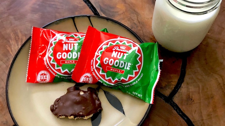 Pearson's Candy Company's Nut Goodie candies in green and red wrappers with a glass of milk on the side