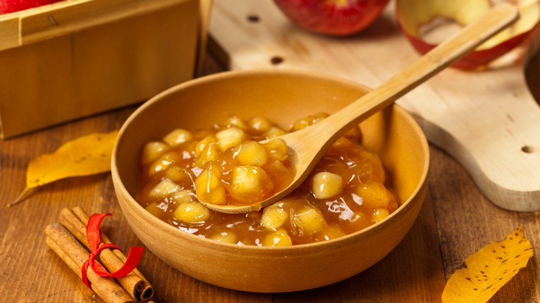 Apple Pie Filling in a wooden bowl with a spoon