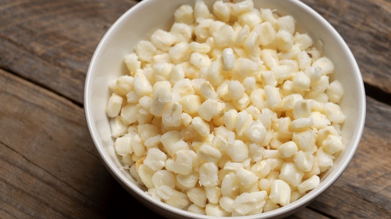 White hominy in a bowl on a wooden table