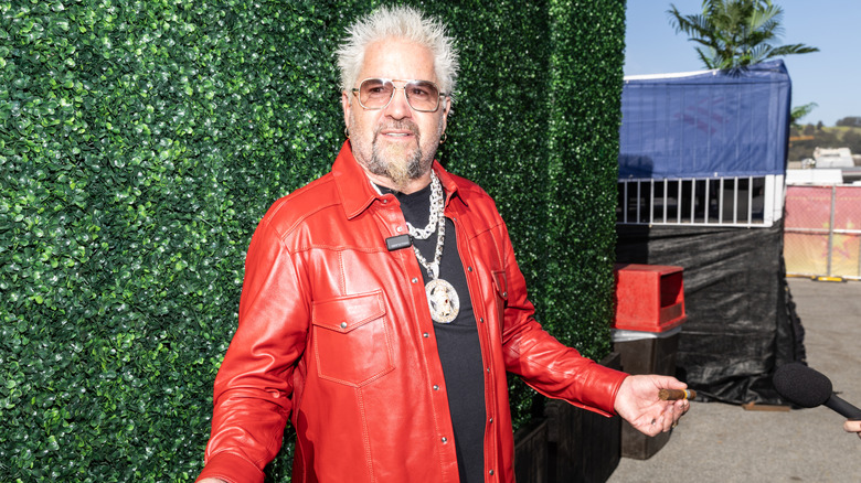 Guy Fieri poses for photos during Guy Fieri's Flavortown Tailgate