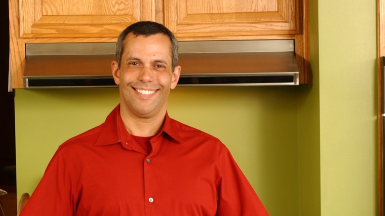 Food Network chef and host of "Calorie Commando" Juan Carlos Cruz smiling in a kitchen