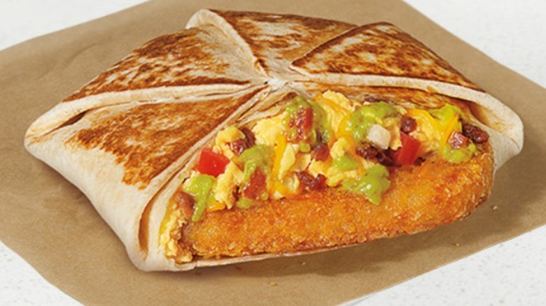 Taco Bell Breakfast California Crunchwrap product image on a brown paper sheet.