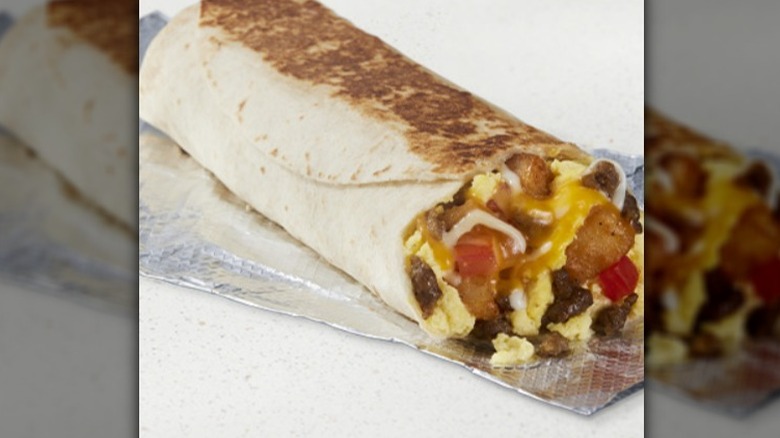 Taco Bell: Grande Toasted Steak Breakfast Burrito on a foil wrapper.