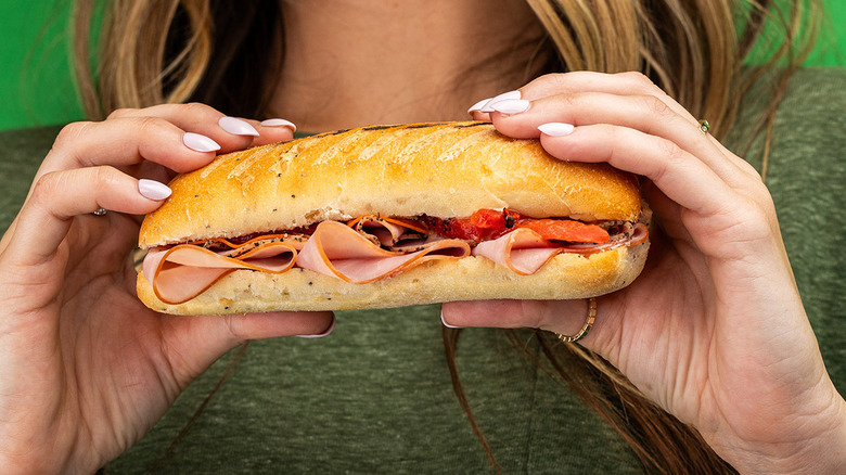 A person holding the Sicilian sub from Blimpie.