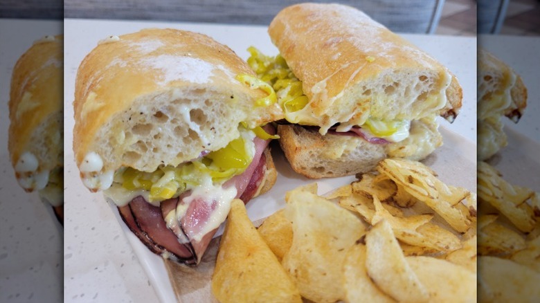 A customer's Toasted Italiano from Panera, on a plate with potato chips