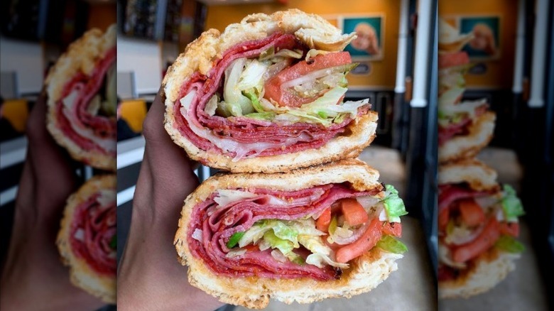 Potbelly's Italian sandwich cut in half, held by a person out of frame.