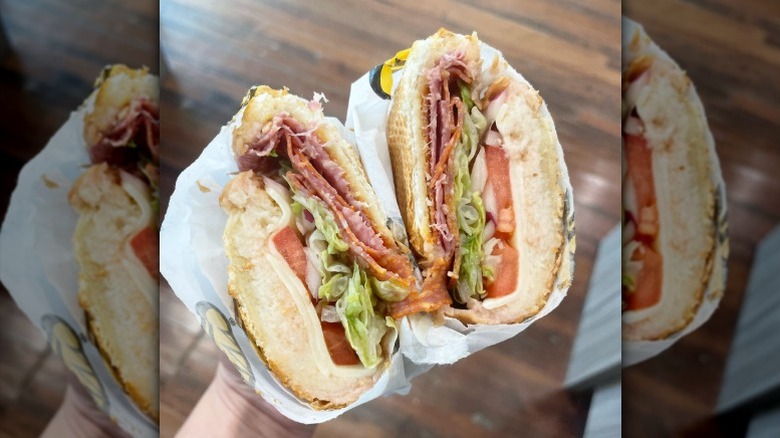 The Grinder from Which Which being held by a hand out of frame