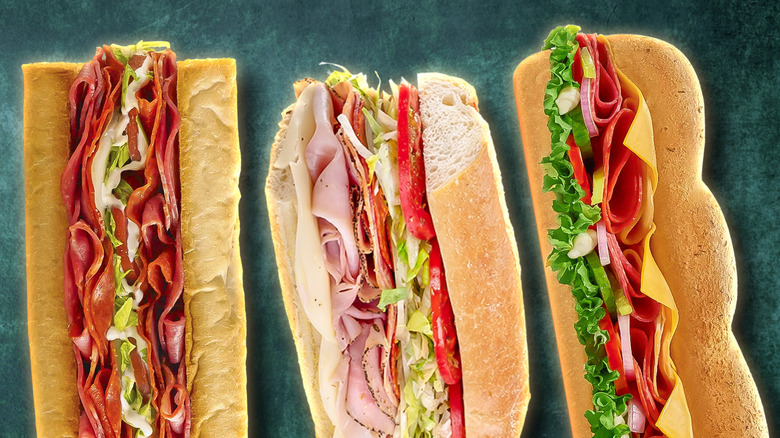 a composite image of 3 Italian sub sandwiches against a dark backdrop