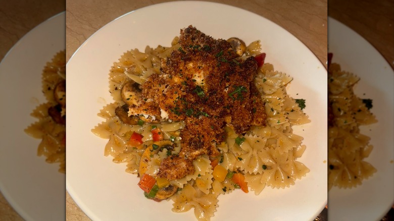 bowtie pasta with sauce, vegetables, and breaded chicken from The Cheesecake Factory