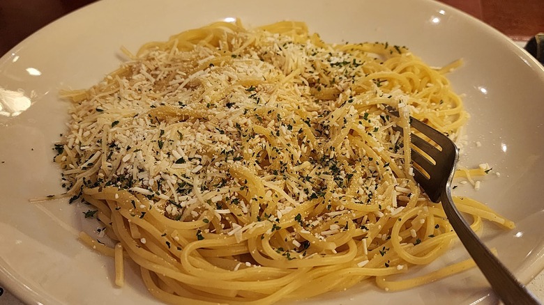 thin spaghetti noodles with mizithra cheese and browned butter in plate at The Old Spaghetti Factory