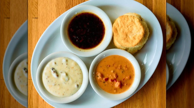 Biscuit with bowls of Sausage gravy, red-eye gravy, and tomato gravy at Big Bad Breakfast