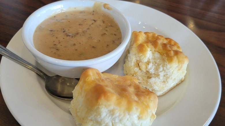 Two Bob Evans Biscuits beside a bowl of gravy