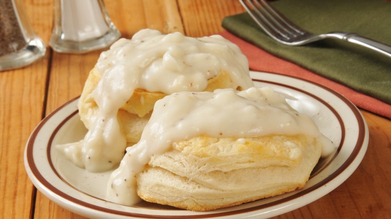 Fresh baked biscuits with country gravy on a rustic wooden table