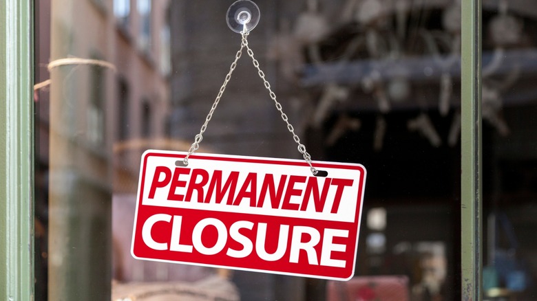 out of business sign hanging in window