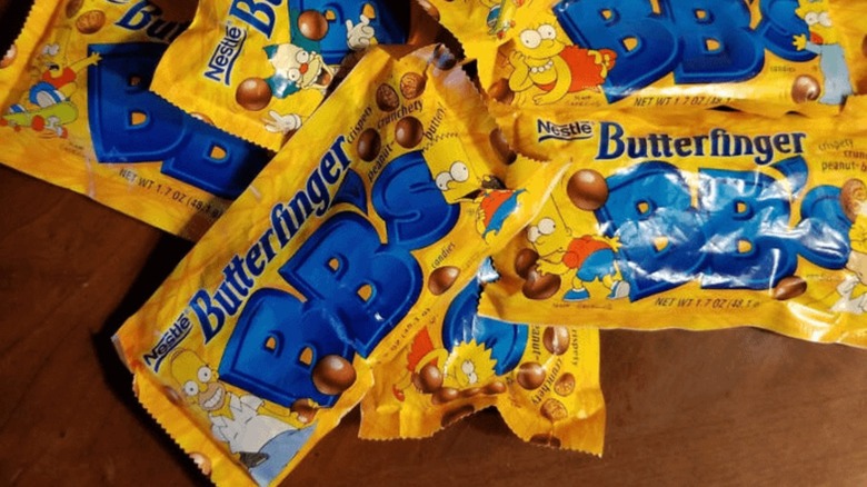 Several Butterfinger BB's packets piled on a wooden table
