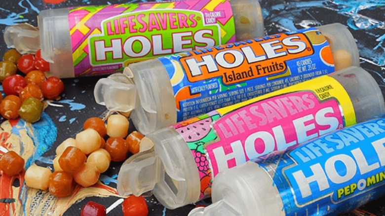 Four packets of various flavors of Life Savers Holes candy