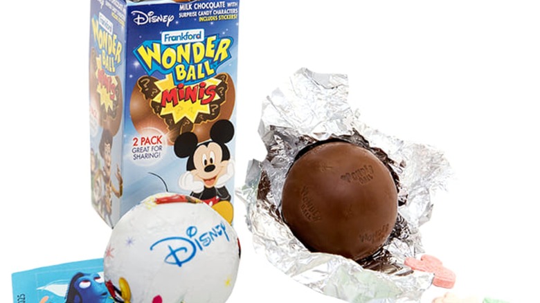 Nestle Wonder Ball candy with box in background. Disney edition. Unwrapped Wonder Ball in aluminum wrapper 