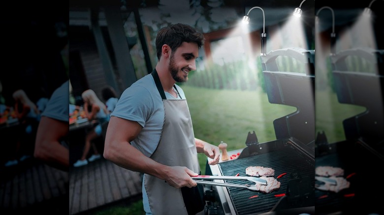 Young man grilling using Jasee barbecue grill lights