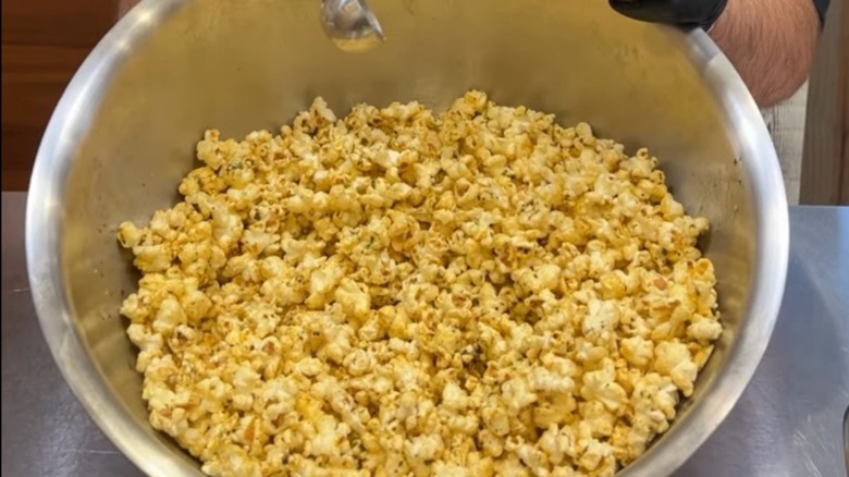Cowboy butter seasoned popcorn in a large silver bowl