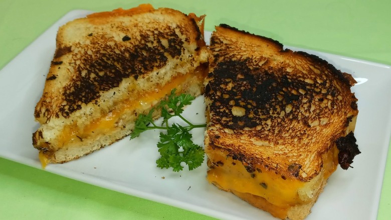 Cowboy butter grilled cheese sandwich garnished with a sprig of parsley