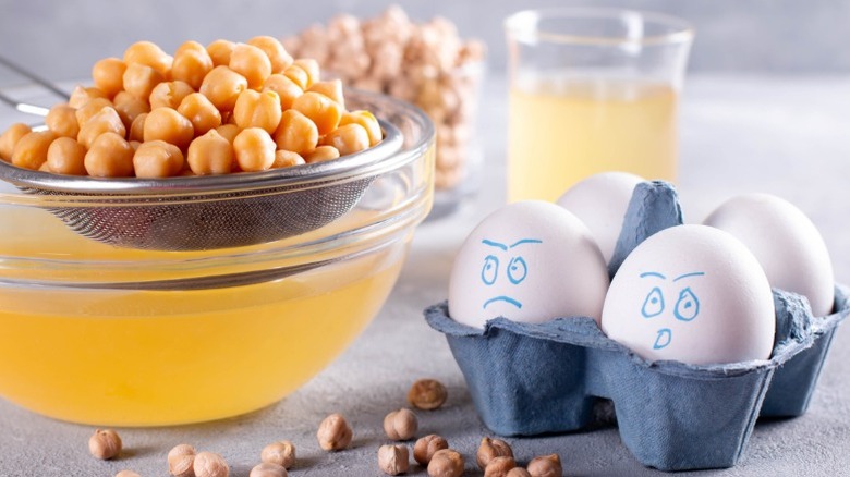 a carton of eggs with shocked faces drawn on them next to a bowl where chickpeas are being strained for aquafaba