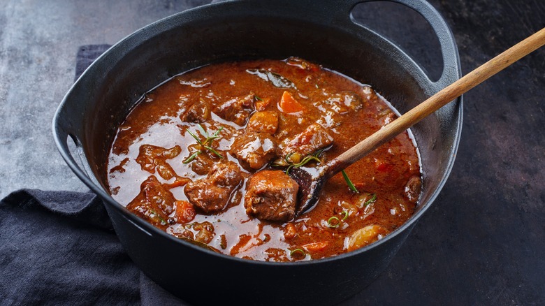 Chunky venison stew in black pot