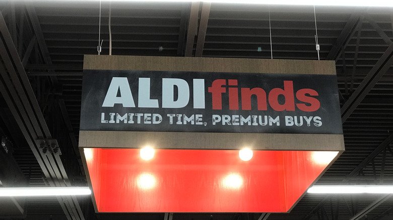 A sign hanging from the ceiling of an Aldi, saying "Aldi Finds, Limited Time, Premium Buys"