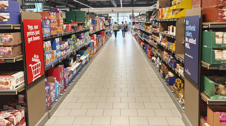 A view of an aisle in Aldi, with two people walking down it