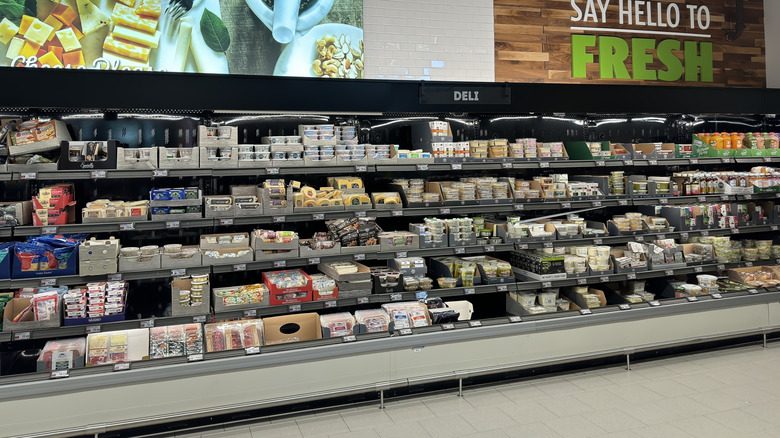 Shelves of packaged deli meats and cheeses inside Aldi
