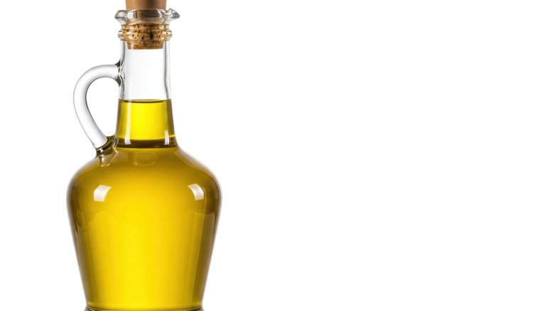Isolated glass bottle of olive oil with a stopper