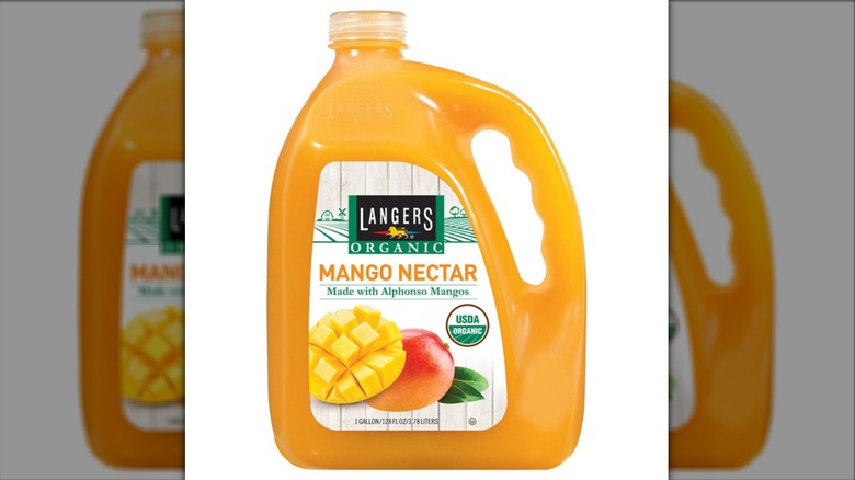 A jug of Langers mango nectar on a white background.