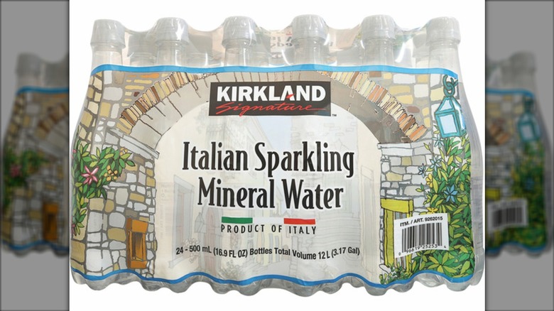 24-pack of Kirkland Signature Italian Sparkling mineral water in 16.9-ounce bottles on a white background.