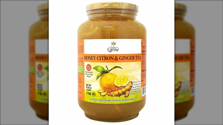 A jar of Balance Grow honey, citron, and ginger tea concentrate on a white background.