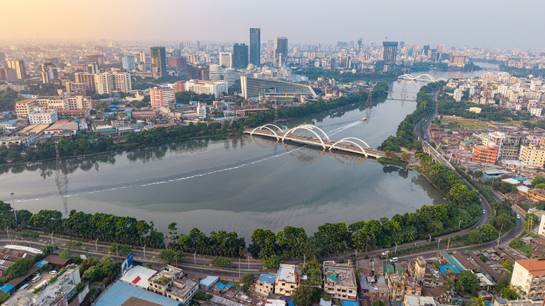 Aerial view of river, bridge, and skyline of Dhaka, Bangladesh