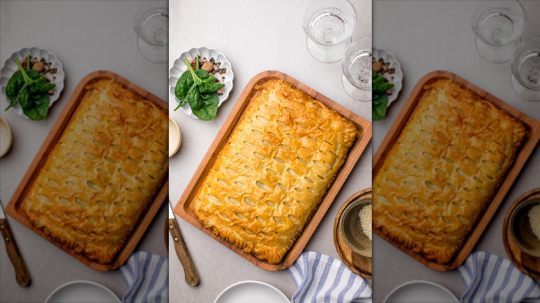An overhead shot of a green bean casserole made with puff pastry, styled on a table.