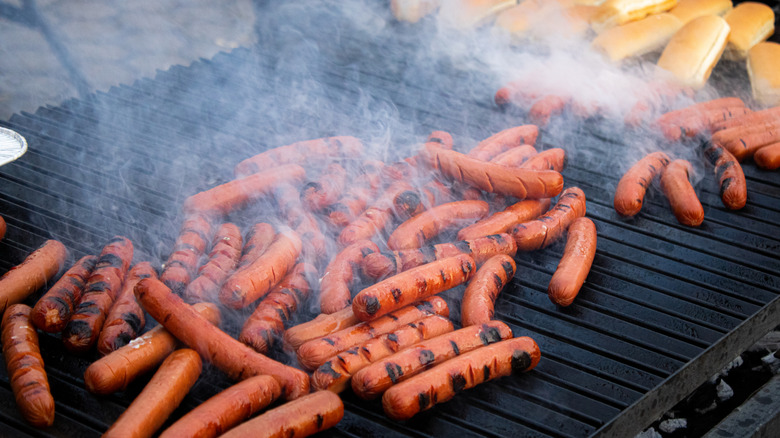 hot dogs on a grill