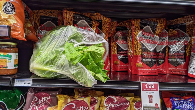 Head of lettuce left on a non-refrigerated grocery store shelf