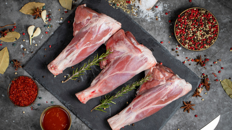 Lamb shank. Raw lamb shank meat on dark background