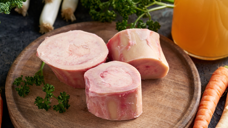 Beef marrow bones and fresh vegetables - ingredients to prepare broth or soup