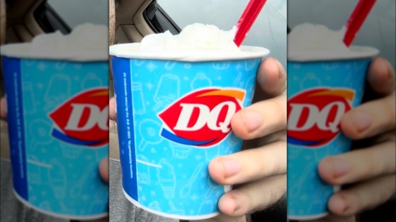 Hand holding a Banana Split Blizzard from Dairy Queen