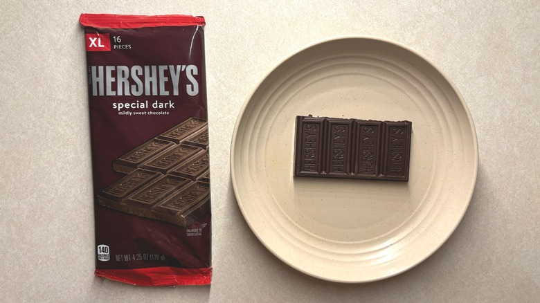 Hershey's Special Dark Mildly Sweet Chocolate XL Candy Bar and chocolate on a plate