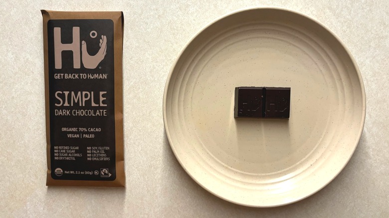 Hu Simple Dark Chocolate 70% Cacao Candy and chocolate on plate