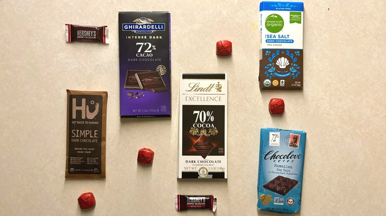 Assorted dark chocolate candy bars on surface